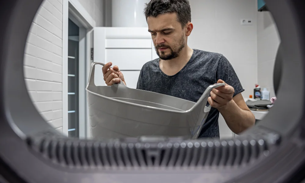 appliance repair expert working on dryer