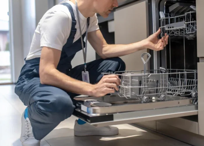 Dishwasher repair technician fixing kitchen dishwasher appliance in Naperville IL