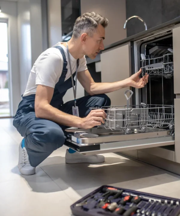 Dishwasher repair technician fixing kitchen dishwasher appliance in Naperville IL