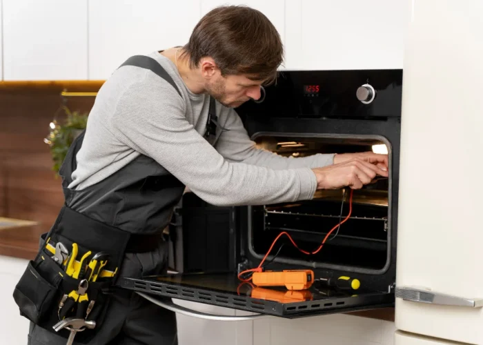 Oven repair specialist repairing electric oven appliance in Naperville Illinois kitchen