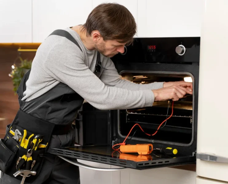 Oven repair specialist repairing electric oven appliance in Naperville Illinois kitchen
