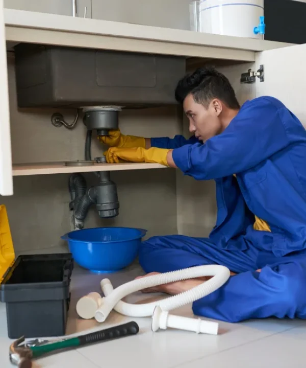 Expert appliance technician repairing disposal unit